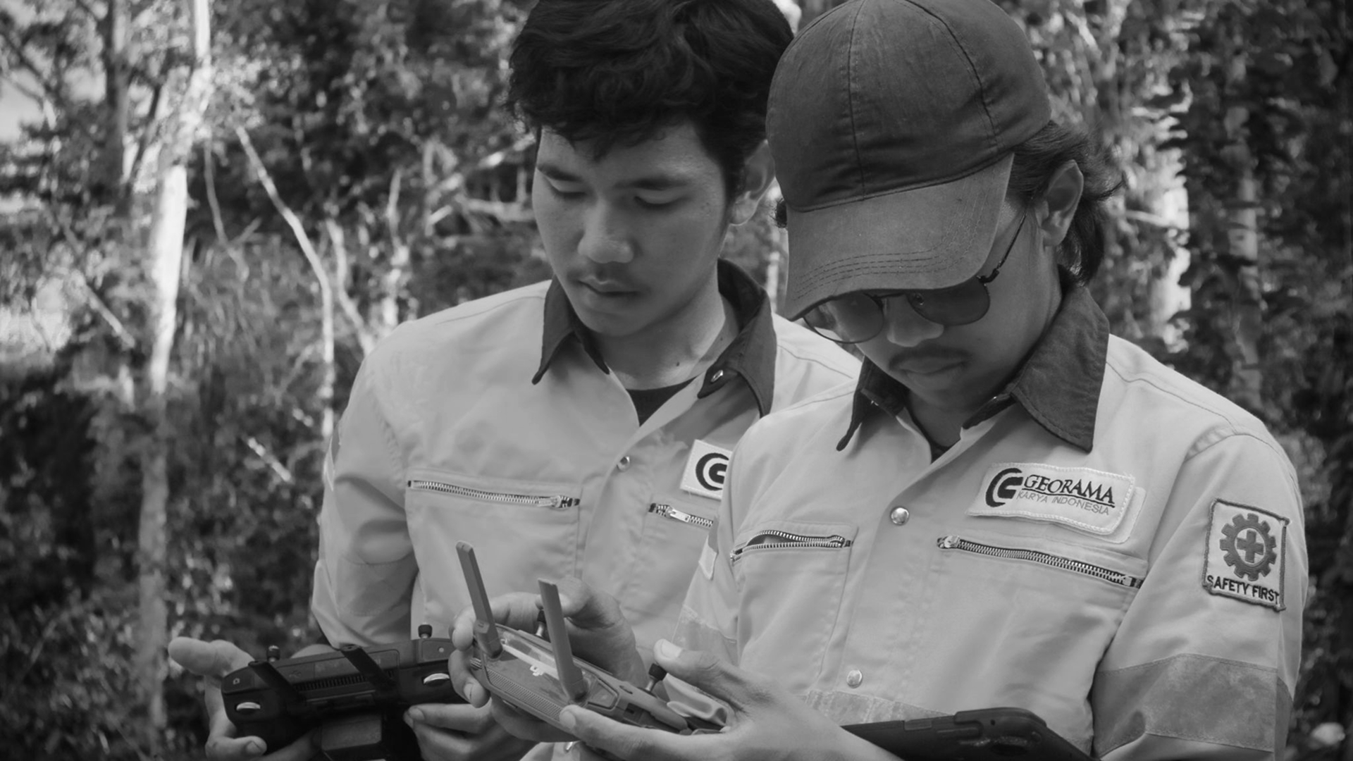 Engineers reviewing technical drawings and field data