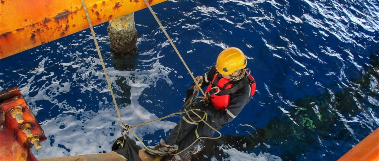 Offshore rope-access technician on subsea platform inspection